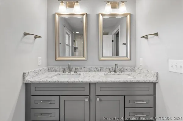 a bathroom with a sink vanity and mirror