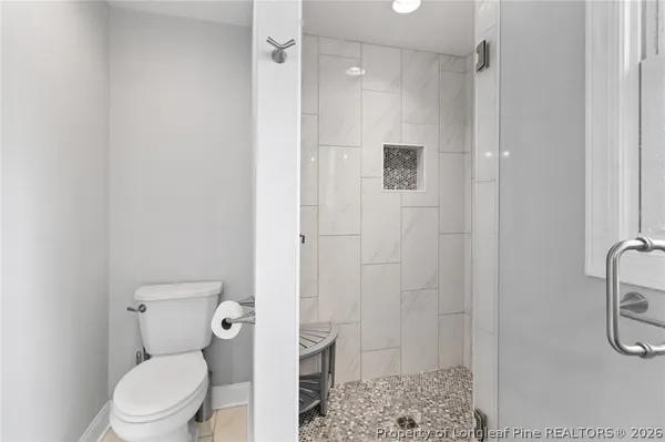 a bathroom with a toilet and a shower