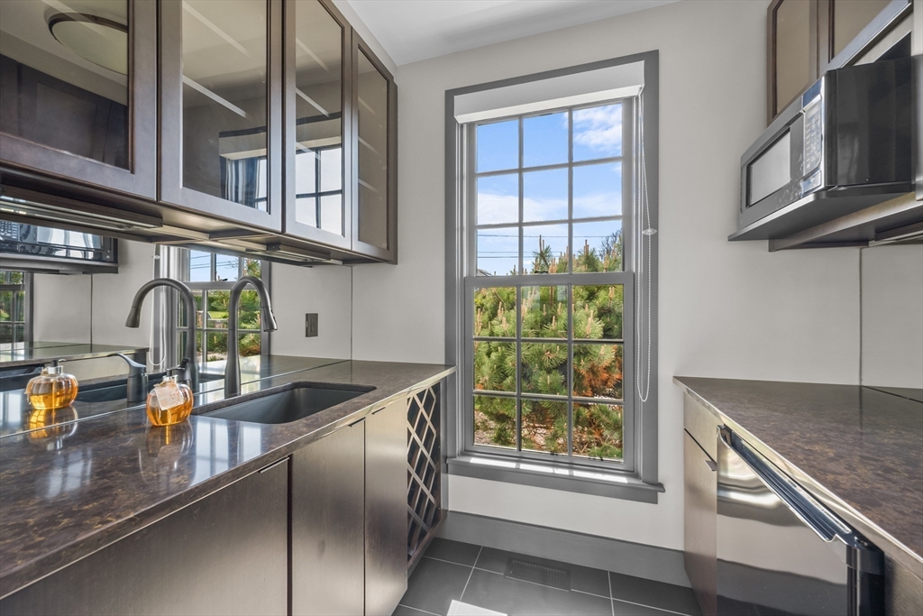 108 Shore Road Chatham, MA 02633 - Photo 17 of 32 a kitchen with stainless steel appliances granite countertop a sink and a window