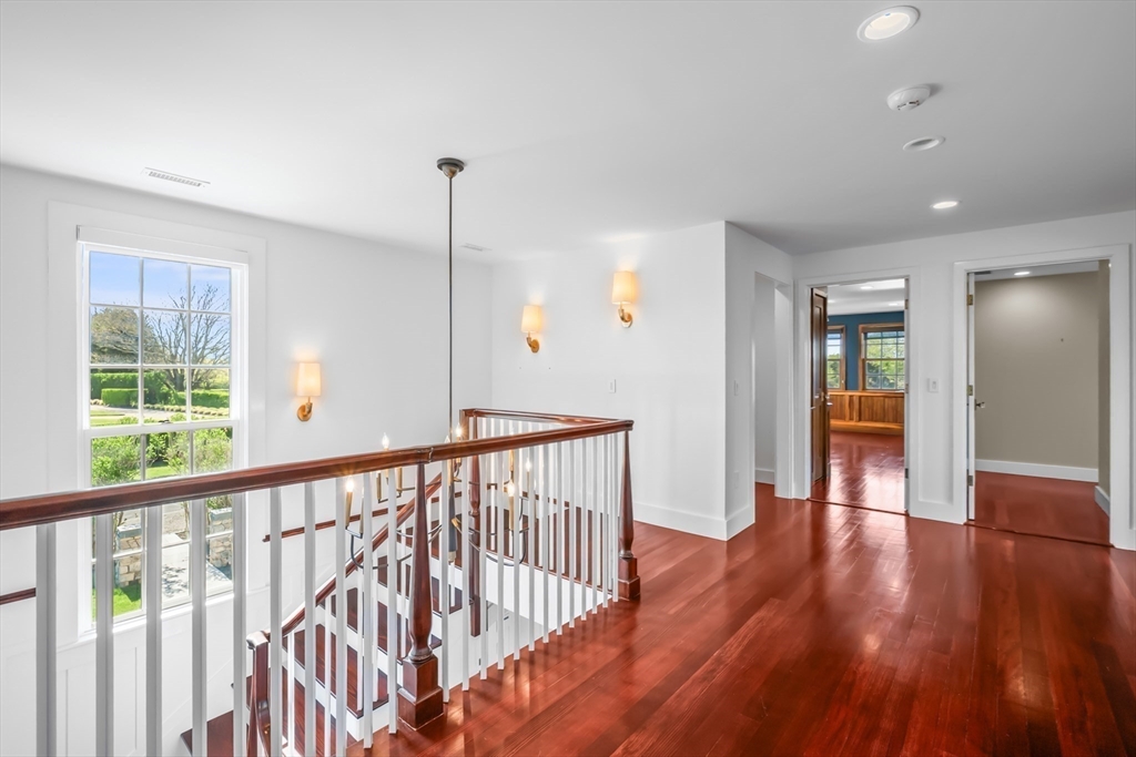 108 Shore Road Chatham, MA 02633 - Photo 23 of 32 a view of a hallway with wooden floor and windows