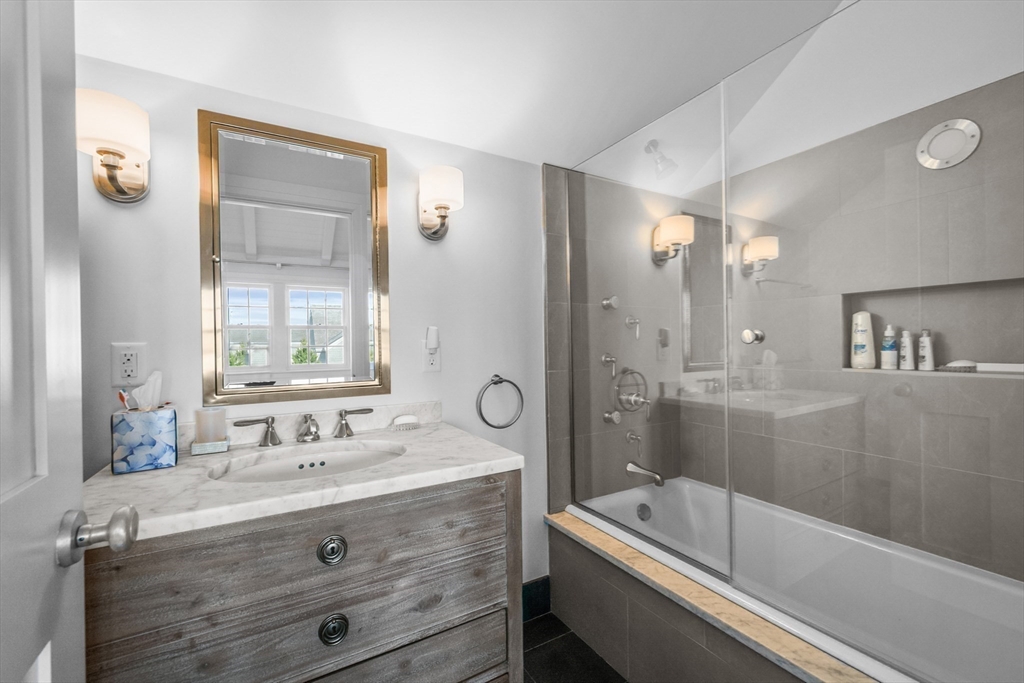 108 Shore Road Chatham, MA 02633 - Photo 32 of 32 a bathroom with a tub a sink and mirror