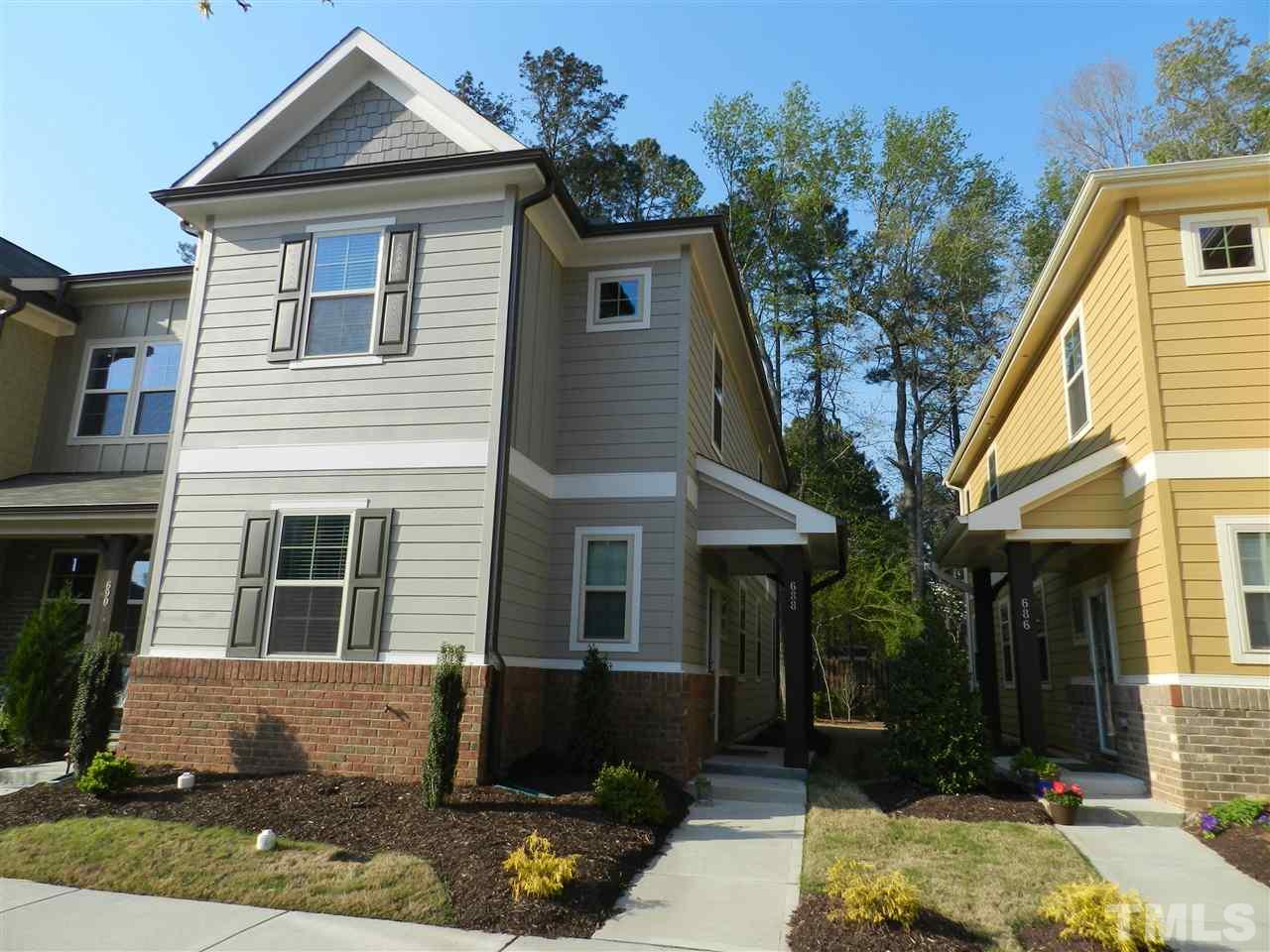 688 Wickham Ridge Road Apex, NC 27539 - Photo 1 of 20 a front view of a house with garden