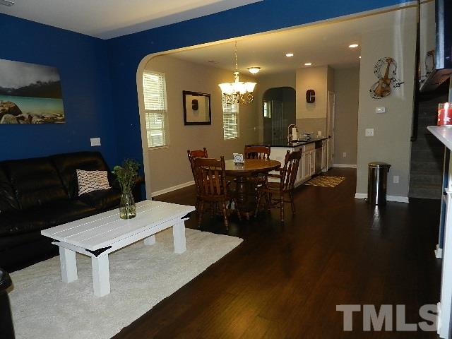 688 Wickham Ridge Road Apex, NC 27539 - Photo 11 of 20 a view of a dining room with furniture and wooden floor