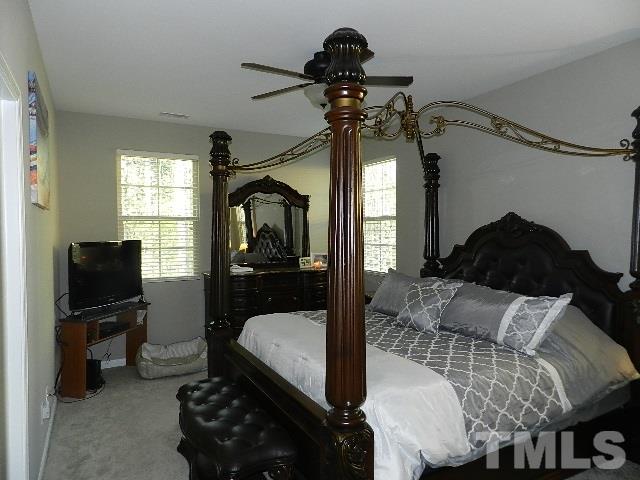 688 Wickham Ridge Road Apex, NC 27539 - Photo 12 of 20 a bedroom with a bed and a tv