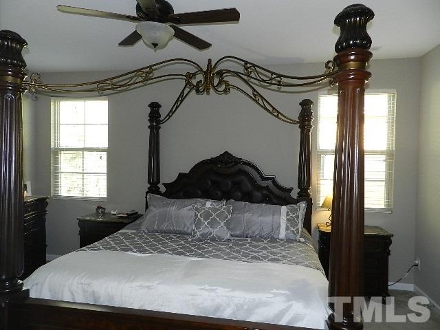 688 Wickham Ridge Road Apex, NC 27539 - Photo 14 of 20 a bedroom with a bed and a window
