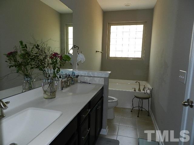 688 Wickham Ridge Road Apex, NC 27539 - Photo 15 of 20 a bathroom with a sink and a mirror