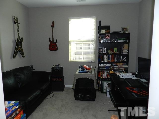 688 Wickham Ridge Road Apex, NC 27539 - Photo 17 of 20 a livingroom with a window and workspace