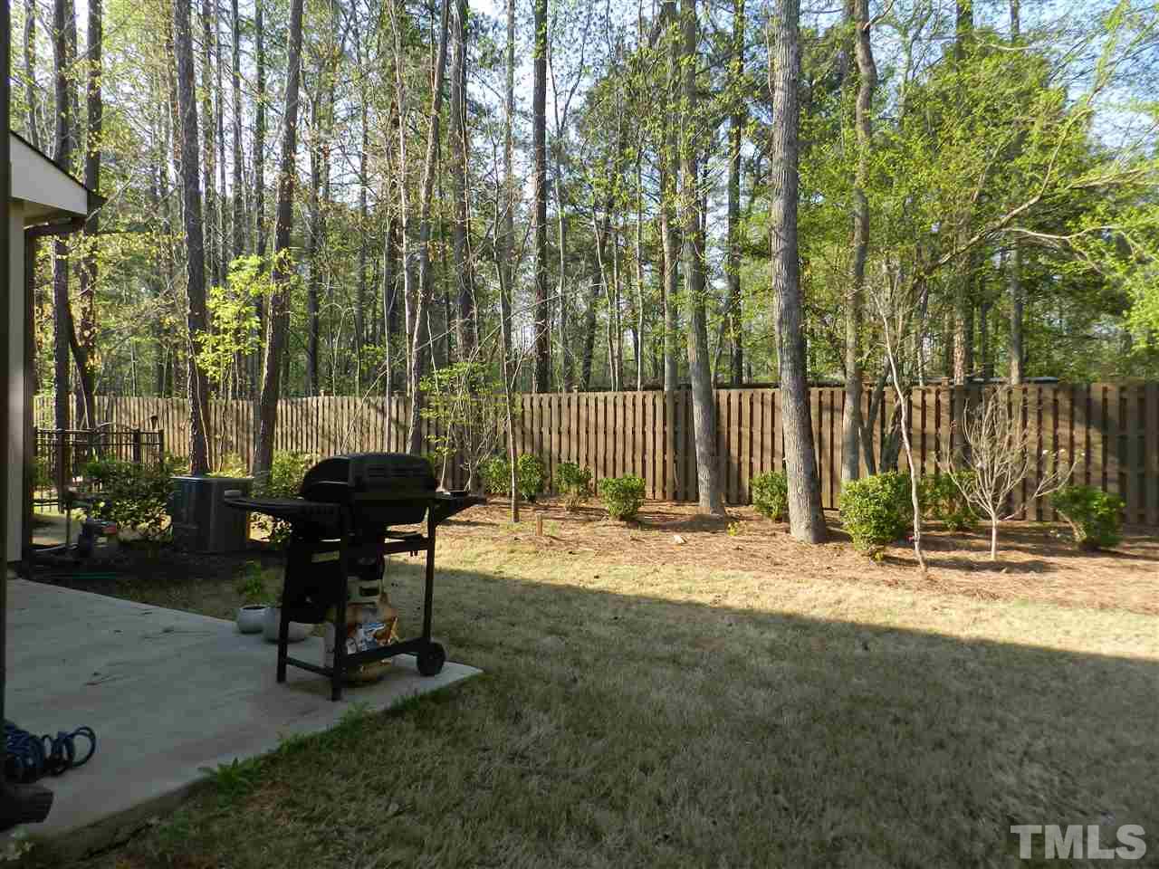 688 Wickham Ridge Road Apex, NC 27539 - Photo 19 of 20 a view of a backyard with a table and chairs