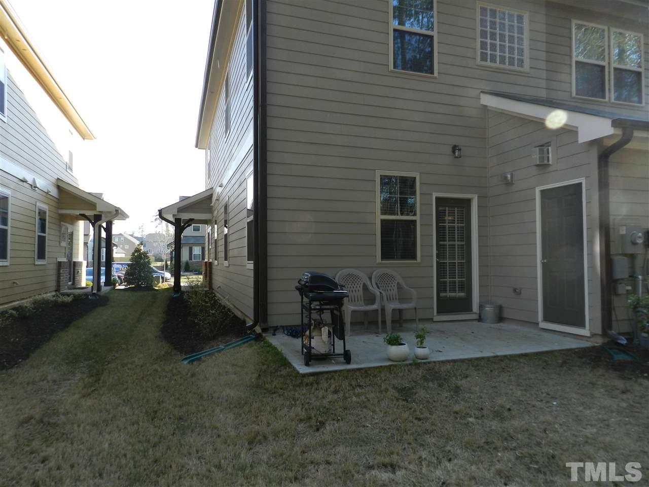 688 Wickham Ridge Road Apex, NC 27539 - Photo 20 of 20 a view of a patio with table and chairs and potted plants
