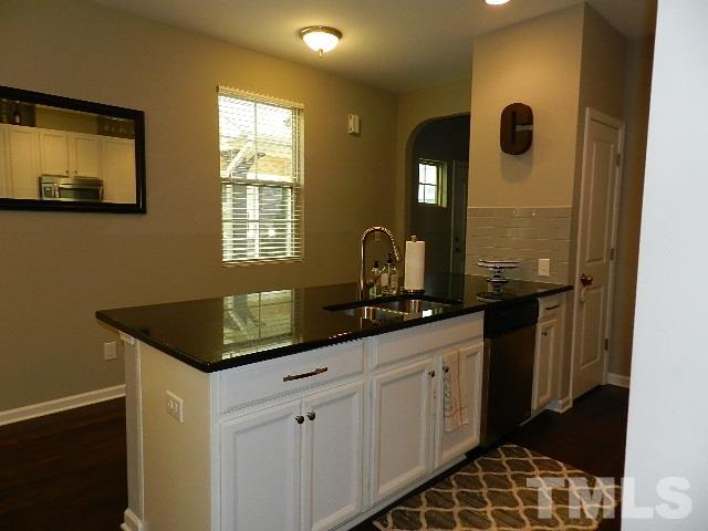 688 Wickham Ridge Road Apex, NC 27539 - Photo 6 of 20 a bathroom with a granite countertop sink a mirror and a shower