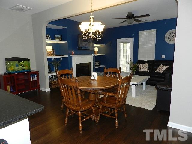 688 Wickham Ridge Road Apex, NC 27539 - Photo 7 of 20 a dining room with furniture a chandelier and wooden floor