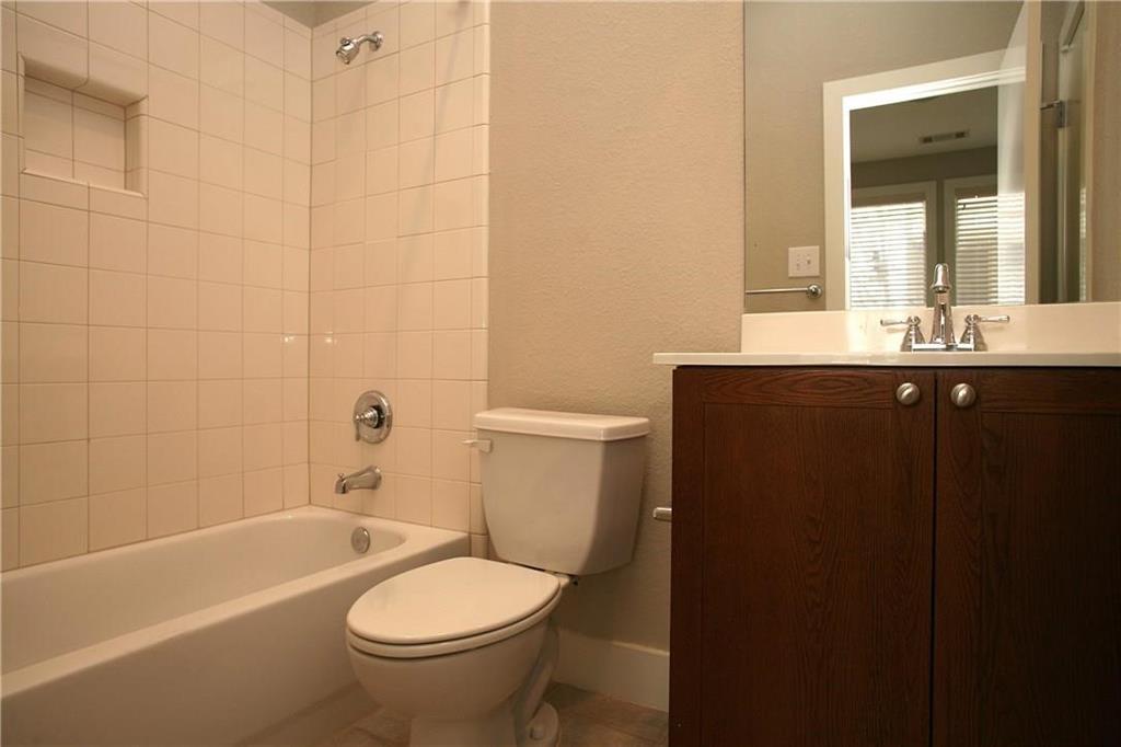 4830 Cedar Springs Road, Unit 43 Dallas, TX 75219 - Photo 11 of 22 Full bathroom featuring tiled shower / bath, toilet, and vanity
