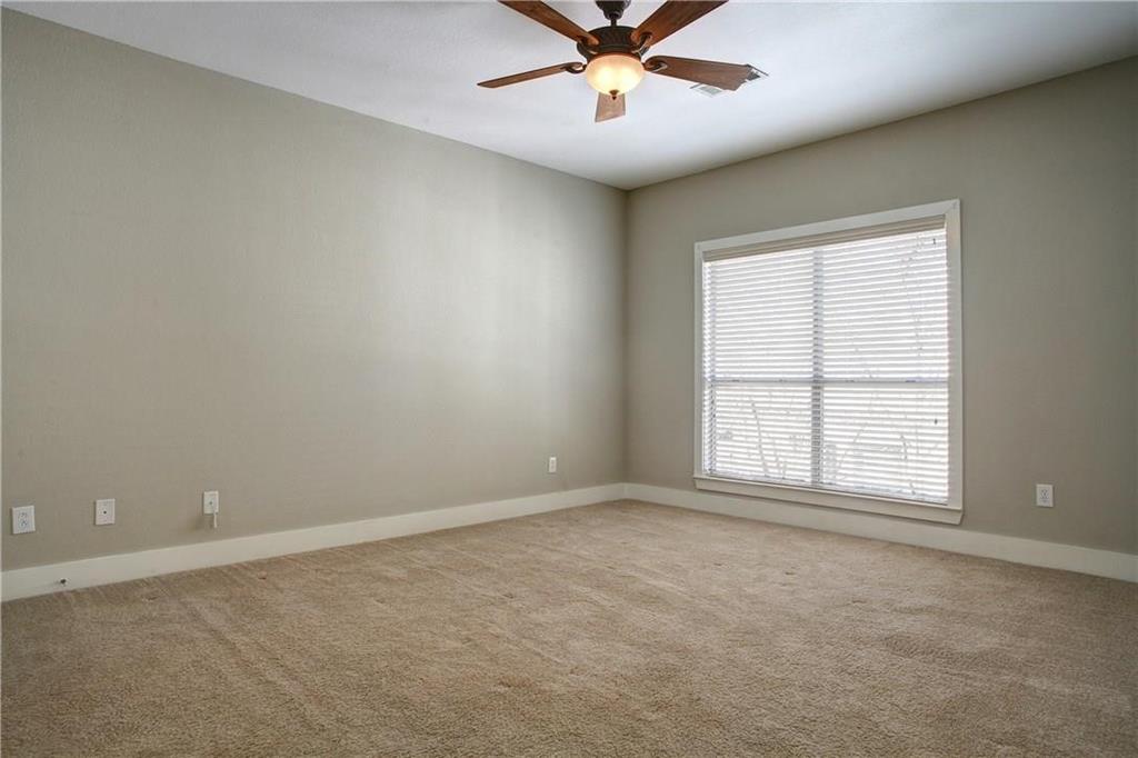 4830 Cedar Springs Road, Unit 43 Dallas, TX 75219 - Photo 12 of 22 Carpeted spare room featuring a healthy amount of sunlight and ceiling fan