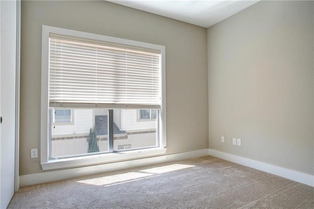 4830 Cedar Springs Road, Unit 43 Dallas, TX 75219 - Photo 16 of 22 Carpeted empty room featuring a wealth of natural light