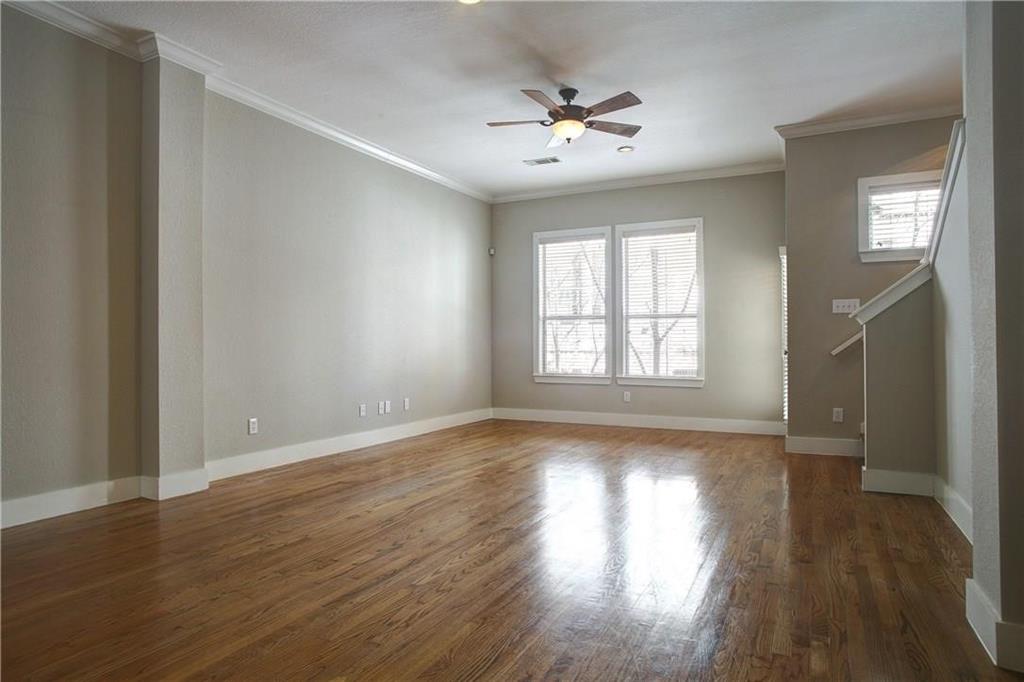 4830 Cedar Springs Road, Unit 43 Dallas, TX 75219 - Photo 4 of 22 Unfurnished room with ornamental molding, ceiling fan, and dark wood-type flooring