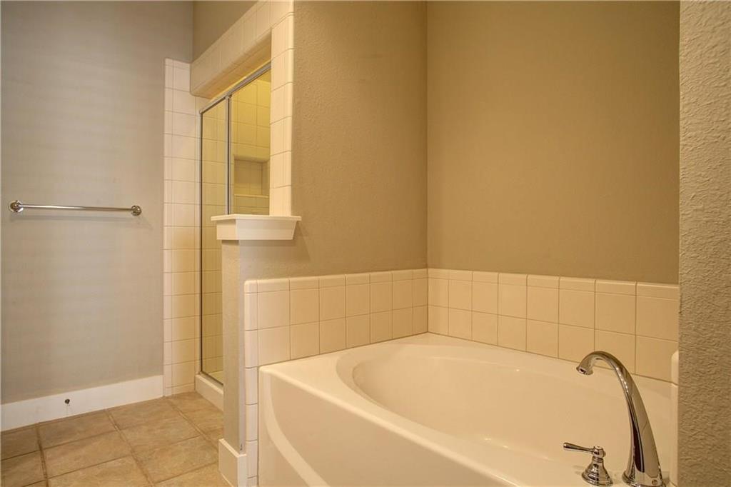 4830 Cedar Springs Road, Unit 43 Dallas, TX 75219 - Photo 9 of 22 Bathroom with tile flooring and plus walk in shower