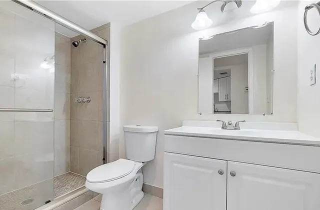 a bathroom with a sink toilet and shower