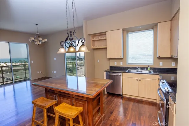 a kitchen with a table chairs stove and wooden floor