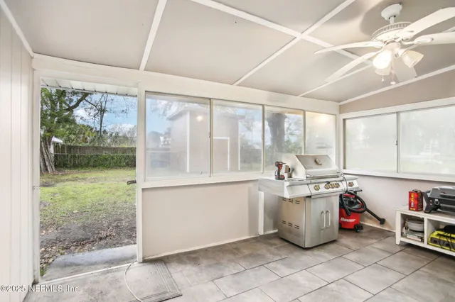 a kitchen with a stove a sink and cabinets