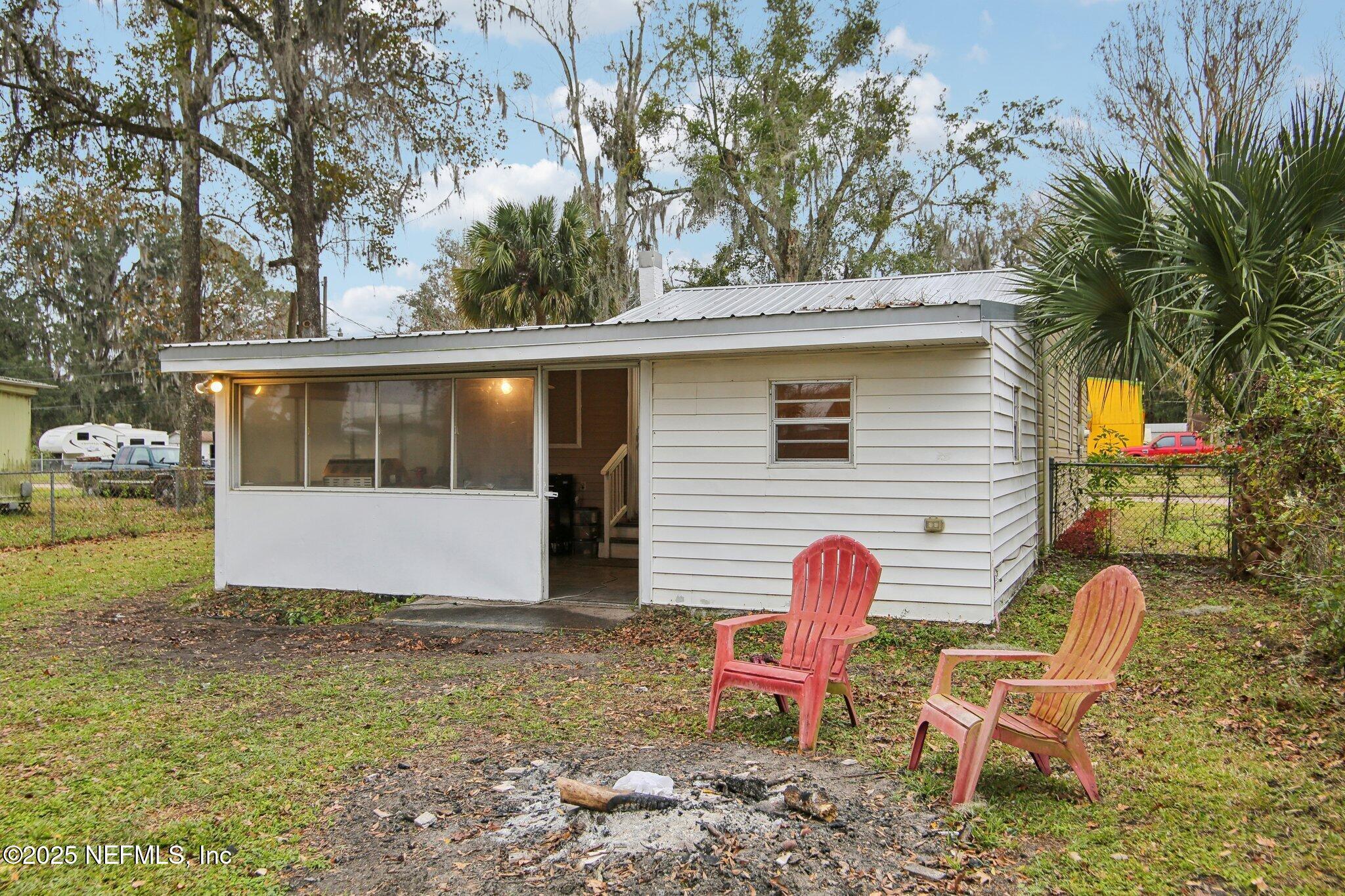 216 West Fox Street Hastings, FL 32145 - Photo 18 of 20 a view of backyard with outdoor seating and covered with trees
