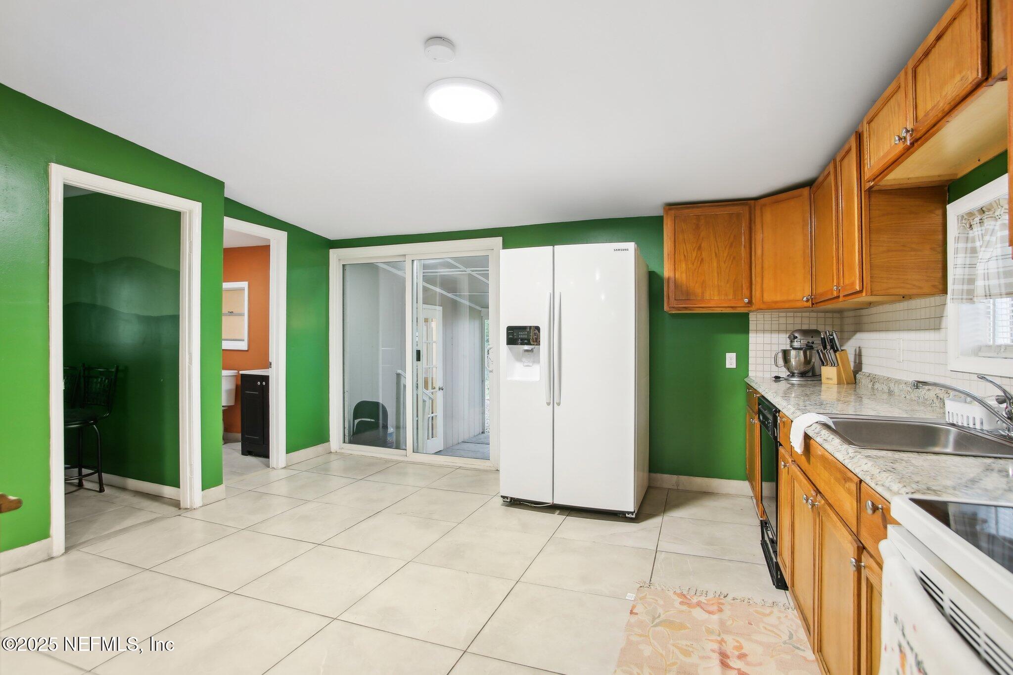 216 West Fox Street Hastings, FL 32145 - Photo 5 of 20 a kitchen with stainless steel appliances granite countertop a refrigerator and a sink