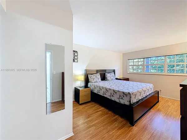 a bedroom with a bed and window