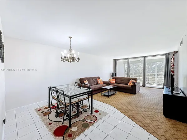 a living room with furniture and a floor to ceiling window