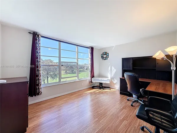 a view of workspace with wooden floor and windows