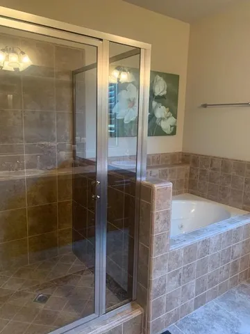 a bathroom with a shower and a bathtub