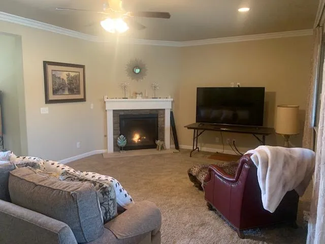 a living room with furniture and a flat screen tv