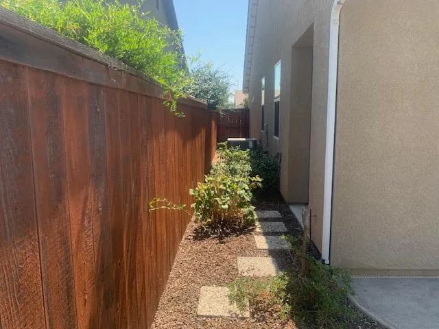 a view of a pathway gate with wooden fence
