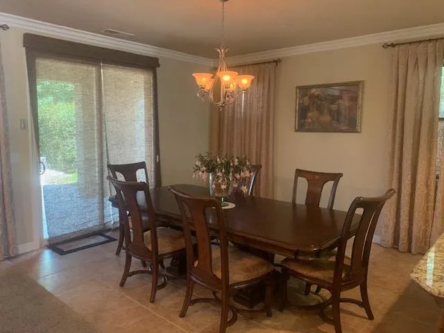 a view of a dining room with furniture window and outside view