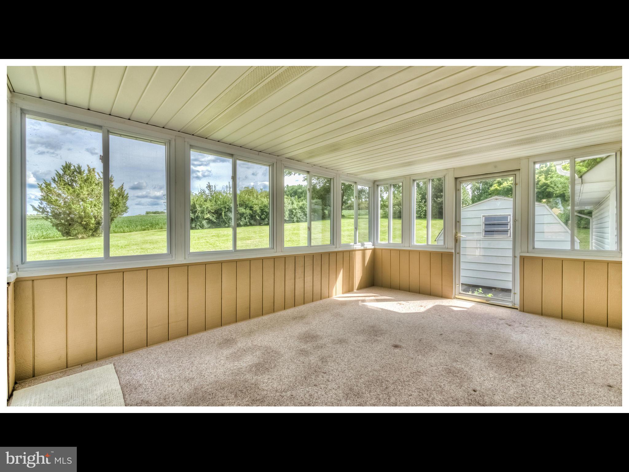 2207 Watervale Road Fallston, MD 21047 - Photo 24 of 30 a view of an empty room with wooden floor and a floor to ceiling window