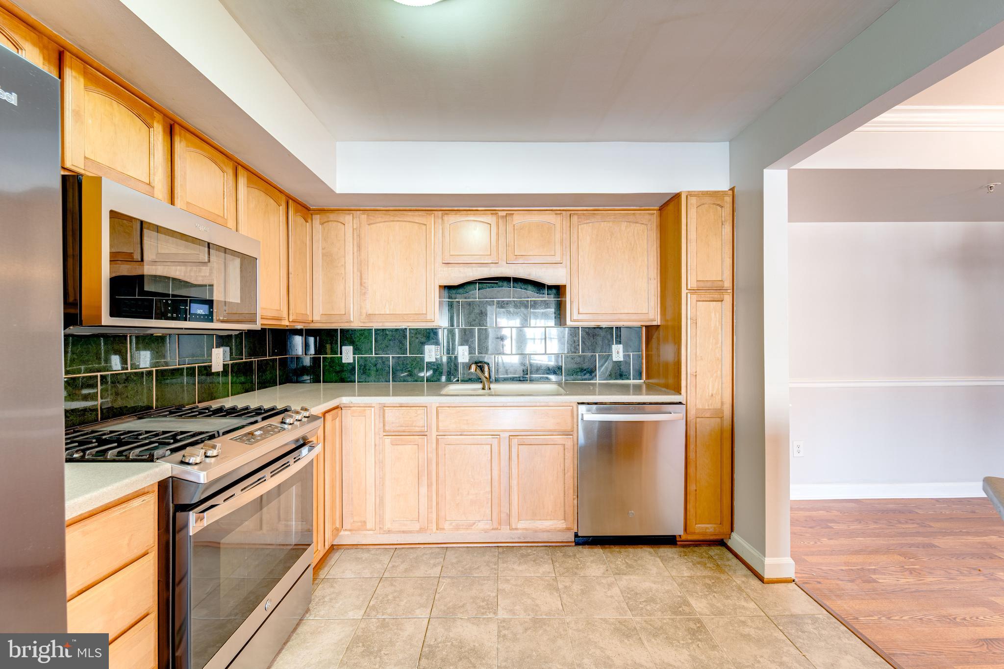 9220 Cardinal Forest Lane, Unit E Lorton, VA 22079 - Photo 12 of 26 a kitchen with stainless steel appliances granite countertop a stove and a sink