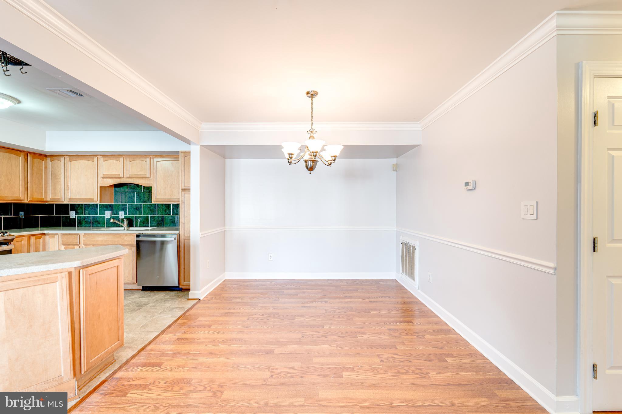 9220 Cardinal Forest Lane, Unit E Lorton, VA 22079 - Photo 13 of 26 a view of a kitchen with wooden floor and a ceiling fan