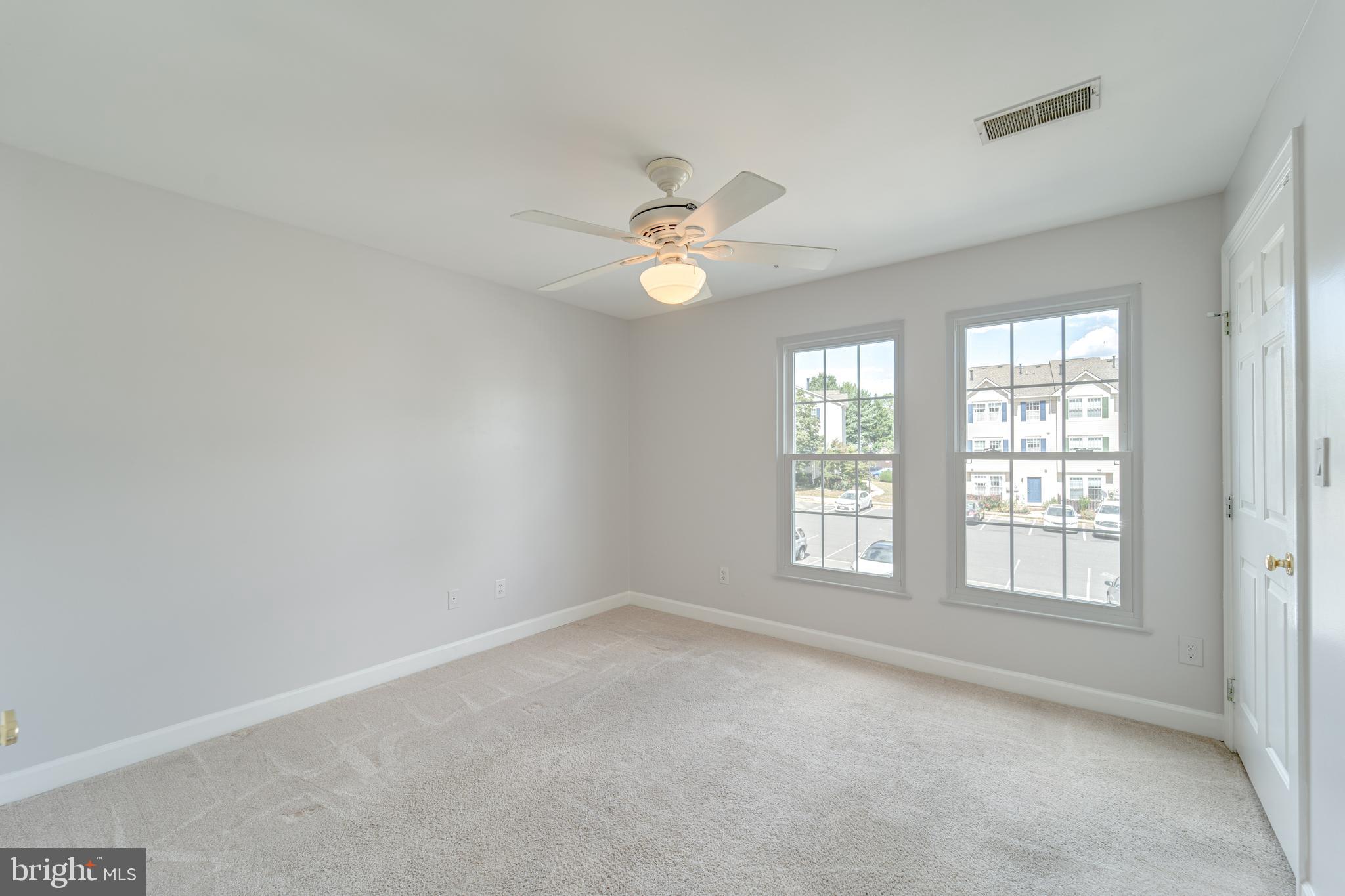 9220 Cardinal Forest Lane, Unit E Lorton, VA 22079 - Photo 14 of 26 an empty room with chandelier fan and windows