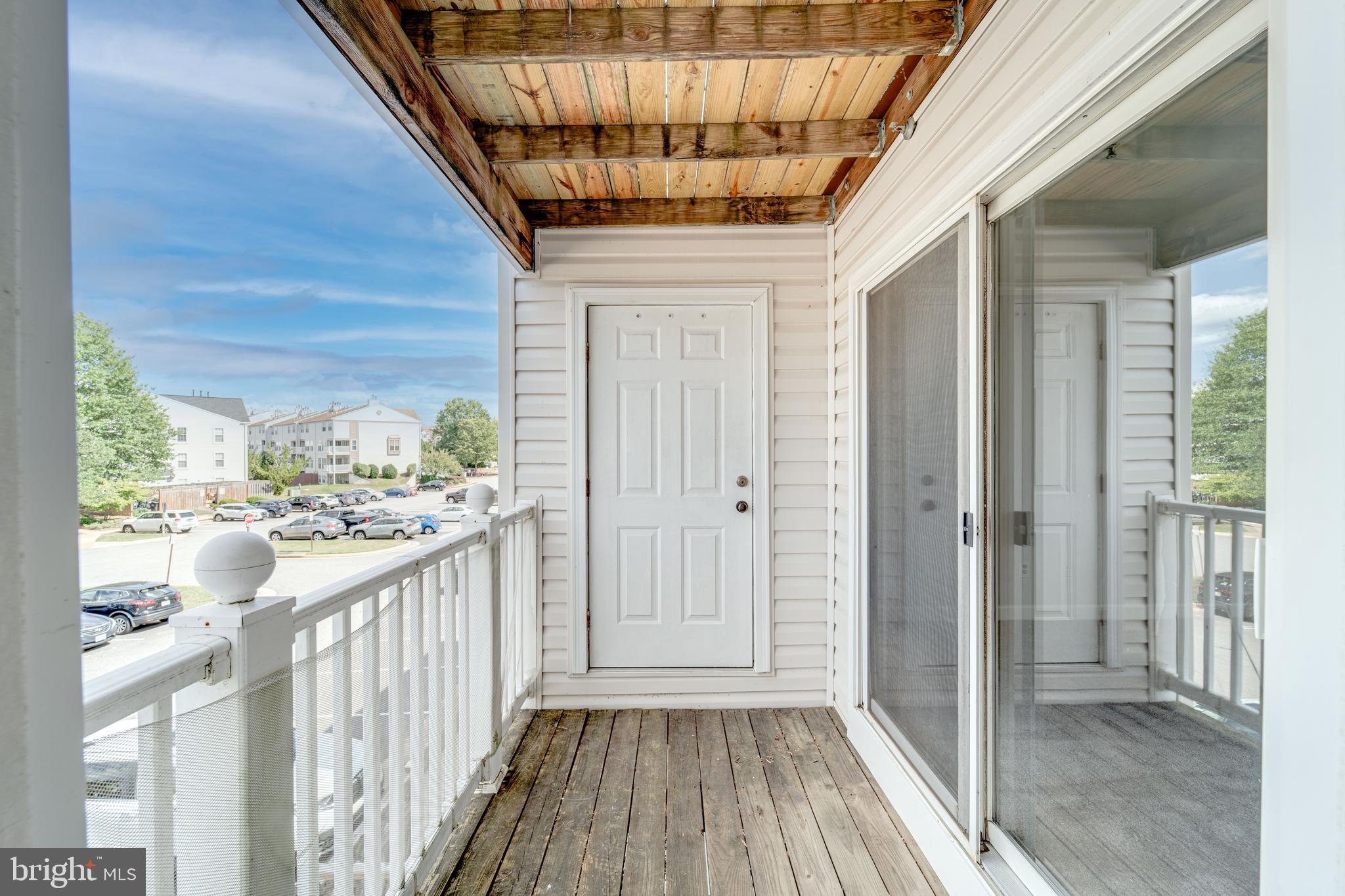9220 Cardinal Forest Lane, Unit E Lorton, VA 22079 - Photo 23 of 26 a view of a porch with wooden floor and stairs