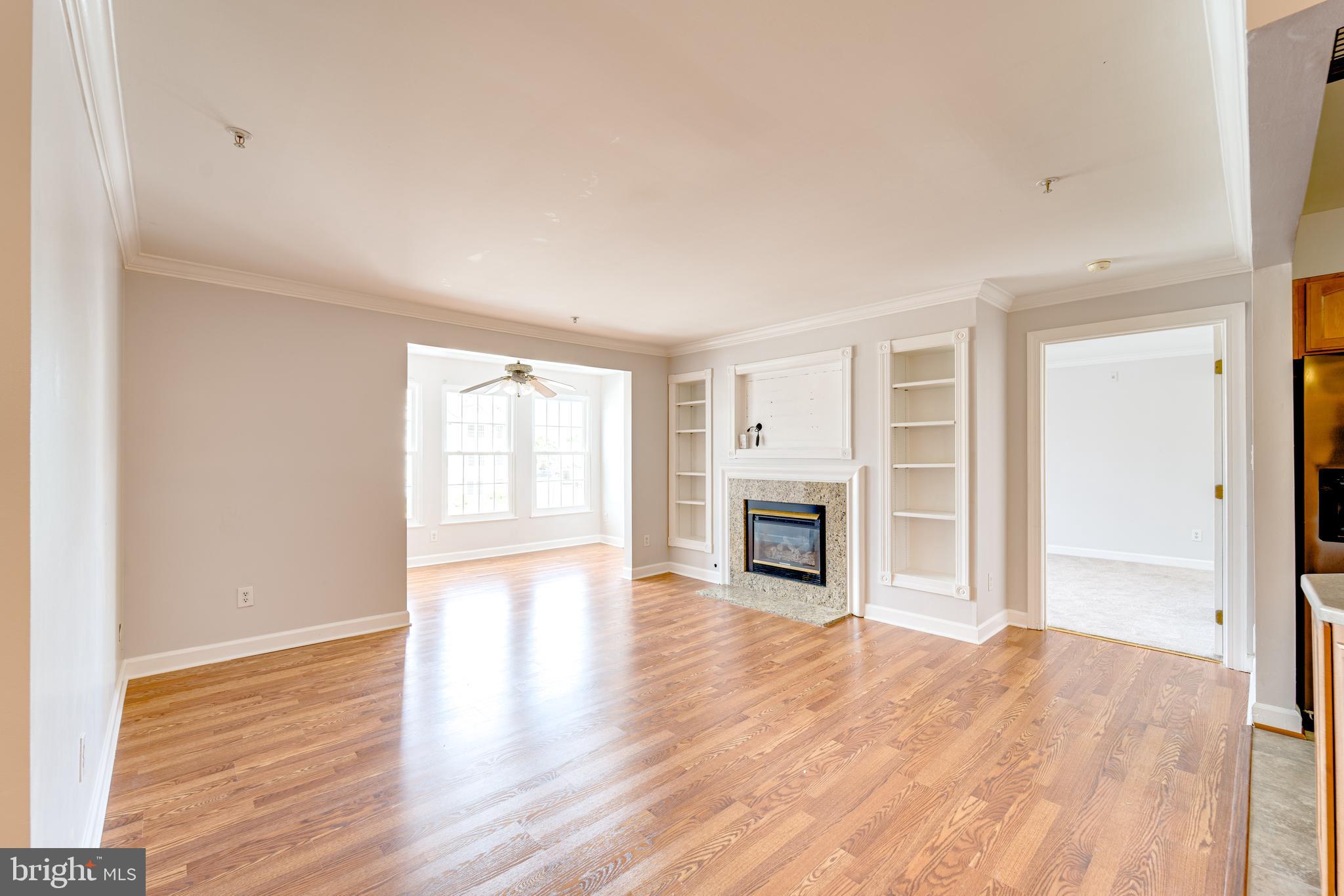 9220 Cardinal Forest Lane, Unit E Lorton, VA 22079 - Photo 3 of 26 a view of empty room with wooden floor and fireplace