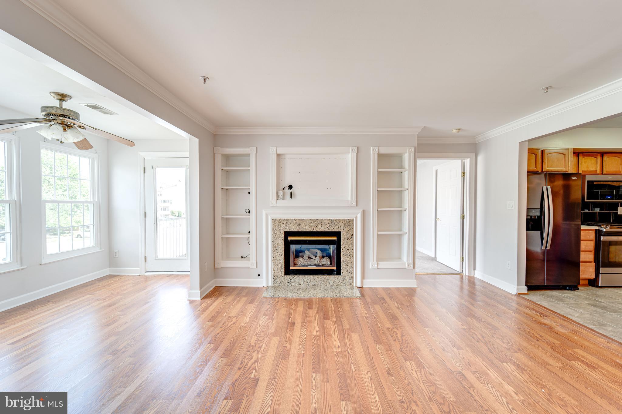 9220 Cardinal Forest Lane, Unit E Lorton, VA 22079 - Photo 5 of 26 an empty room with windows and a fireplace