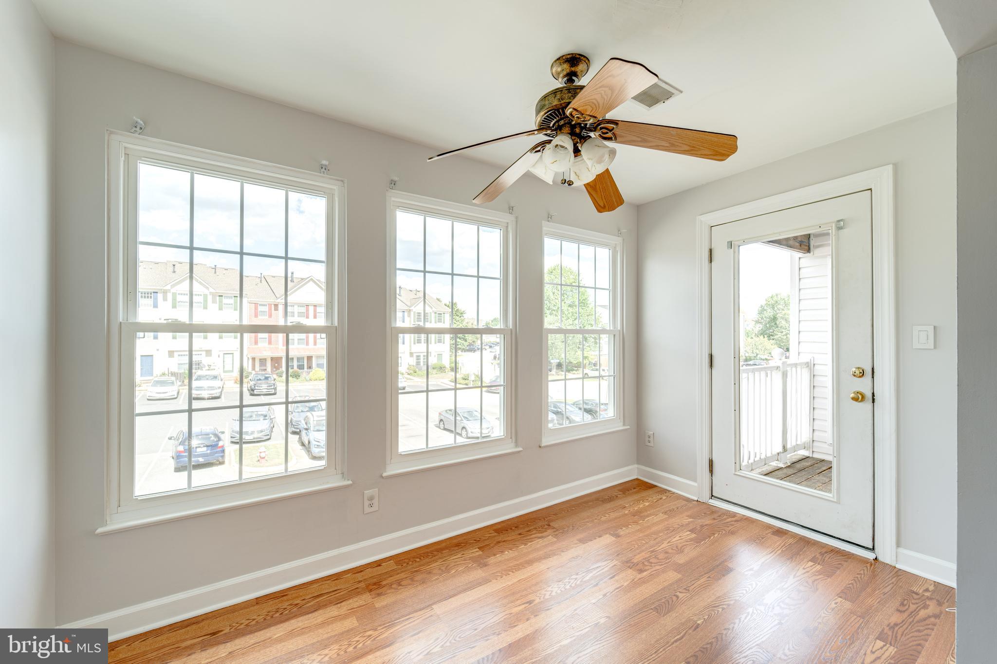 9220 Cardinal Forest Lane, Unit E Lorton, VA 22079 - Photo 6 of 26 a view of an empty room window and wooden floor