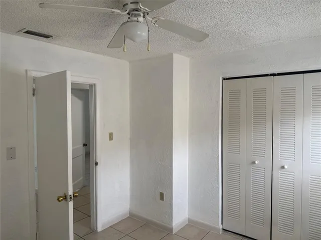 a view of a chandelier fan and entryway
