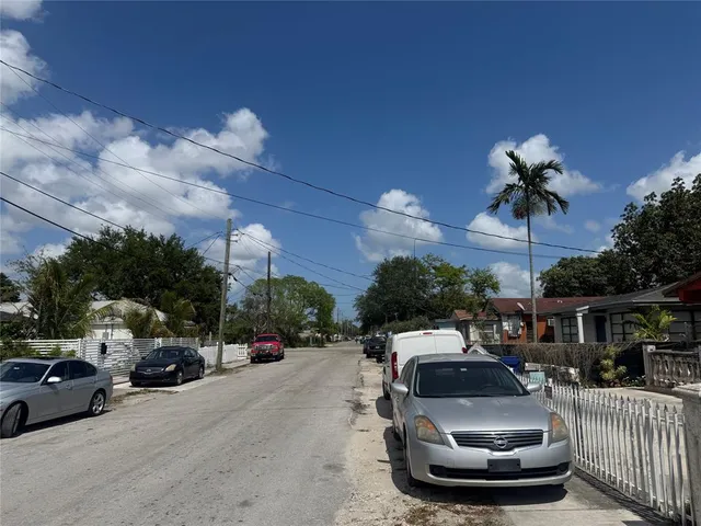 a view of a cars park in front of a building