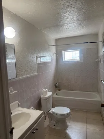 a bathroom with a toilet a sink and bathtub