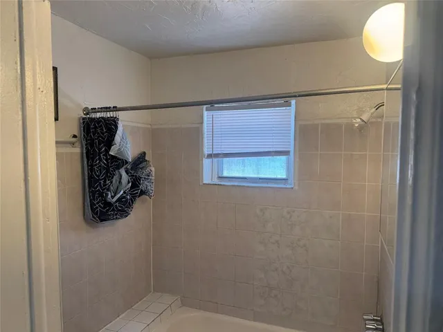 a bathroom with a walk in closet and a mirror