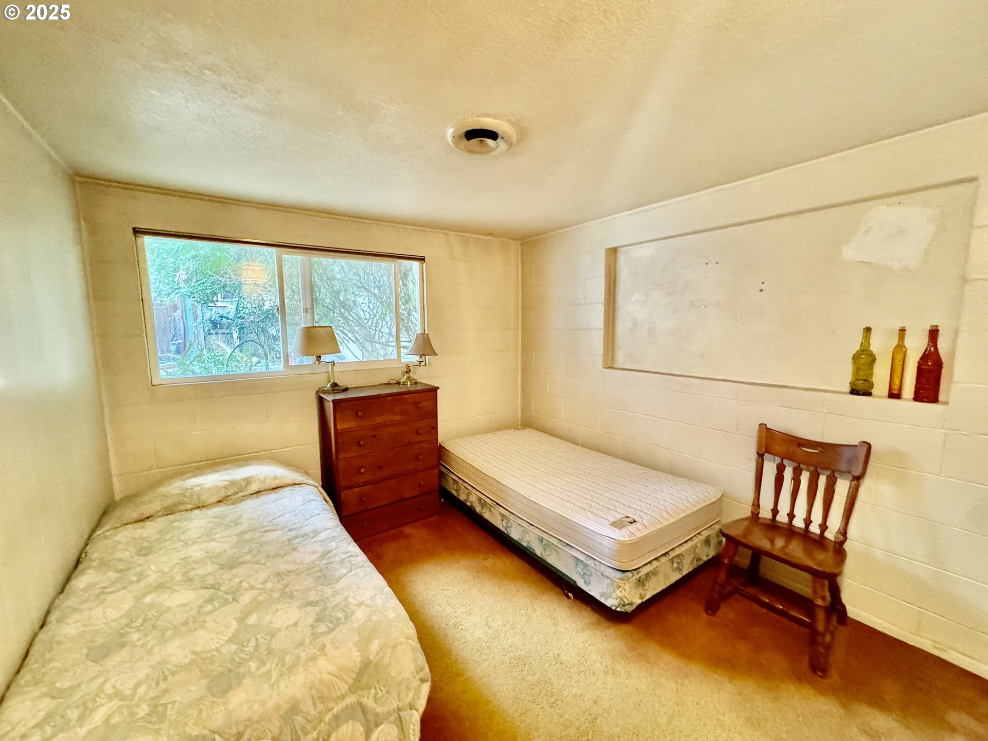 4990 Mitchell Loop Road Florence, OR 97439 - Photo 24 of 37 a bedroom with a bed and a window