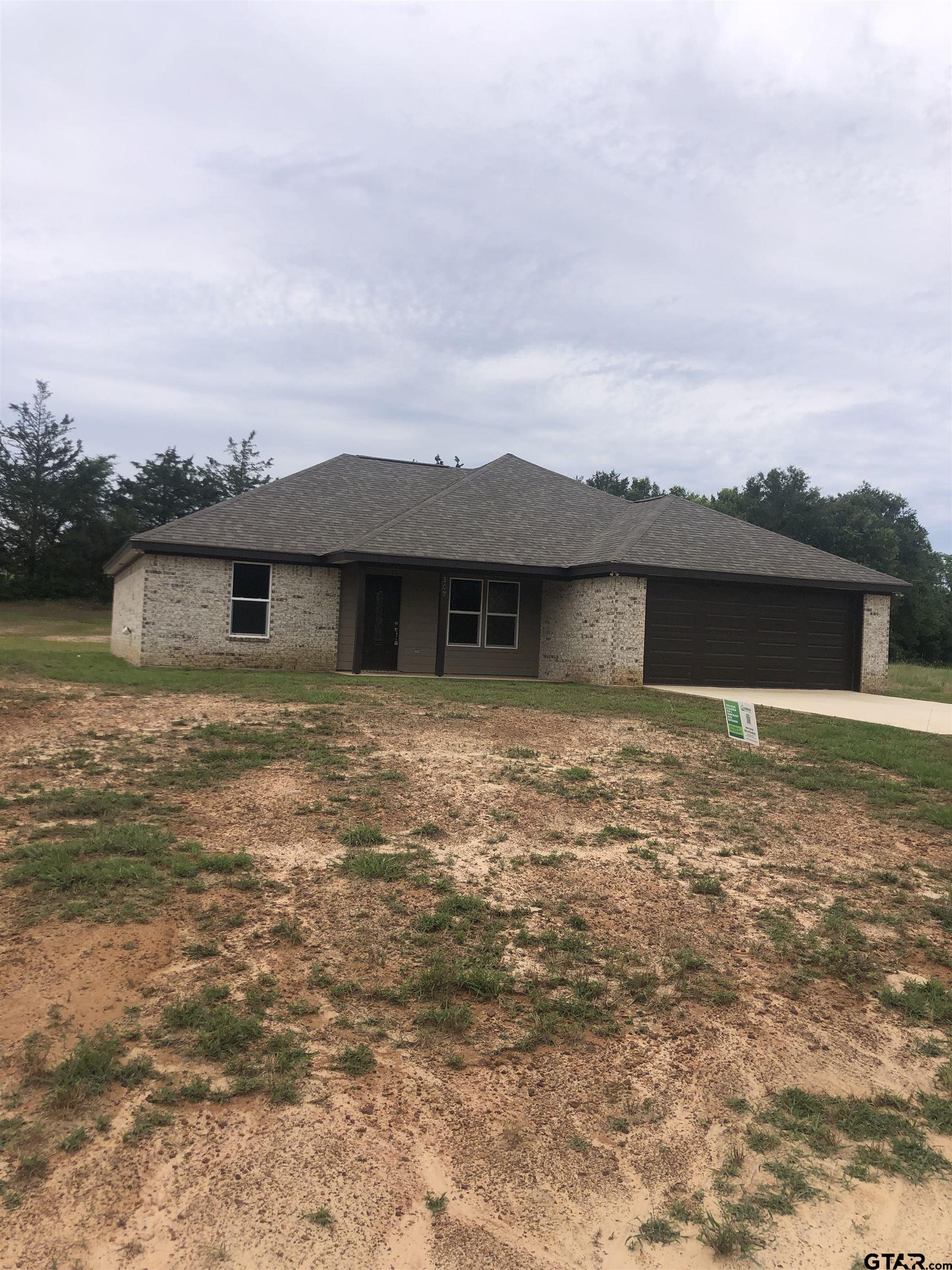 107 Meadow Lane Naples, TX 75568 - Photo 1 of 16 a front view of a house with a yard