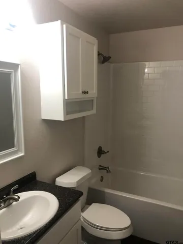 a bathroom with a toilet a sink and bathtub