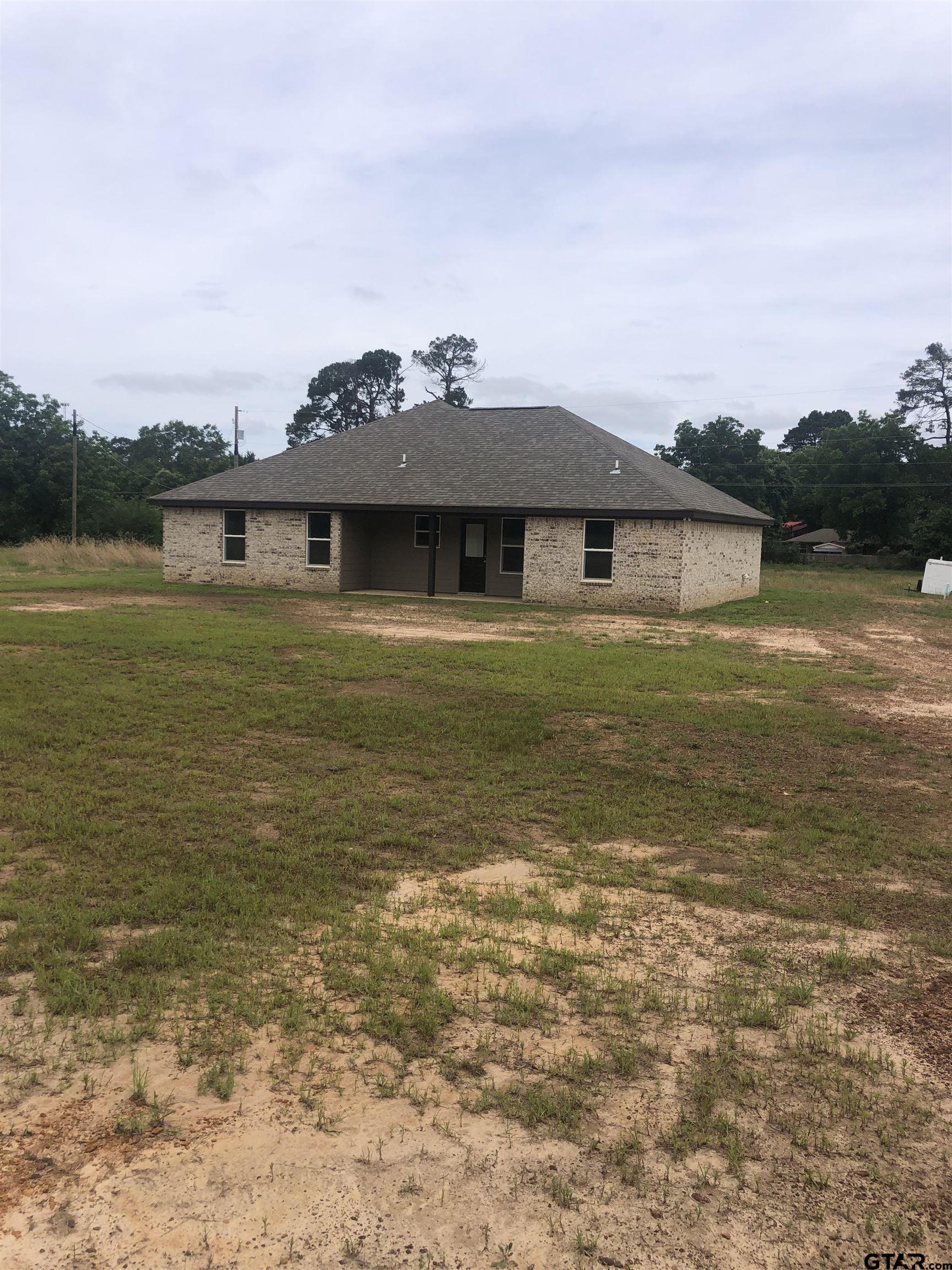 107 Meadow Lane Naples, TX 75568 - Photo 2 of 16 a front view of a house with a ocean view