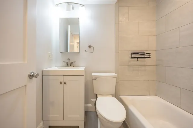 a white toilet sitting next to a bathroom sink