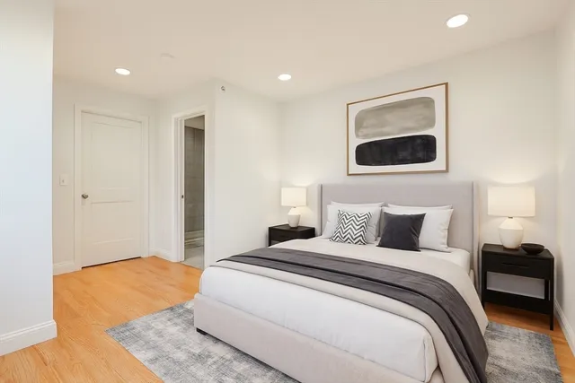 a bedroom with a bed and a painting